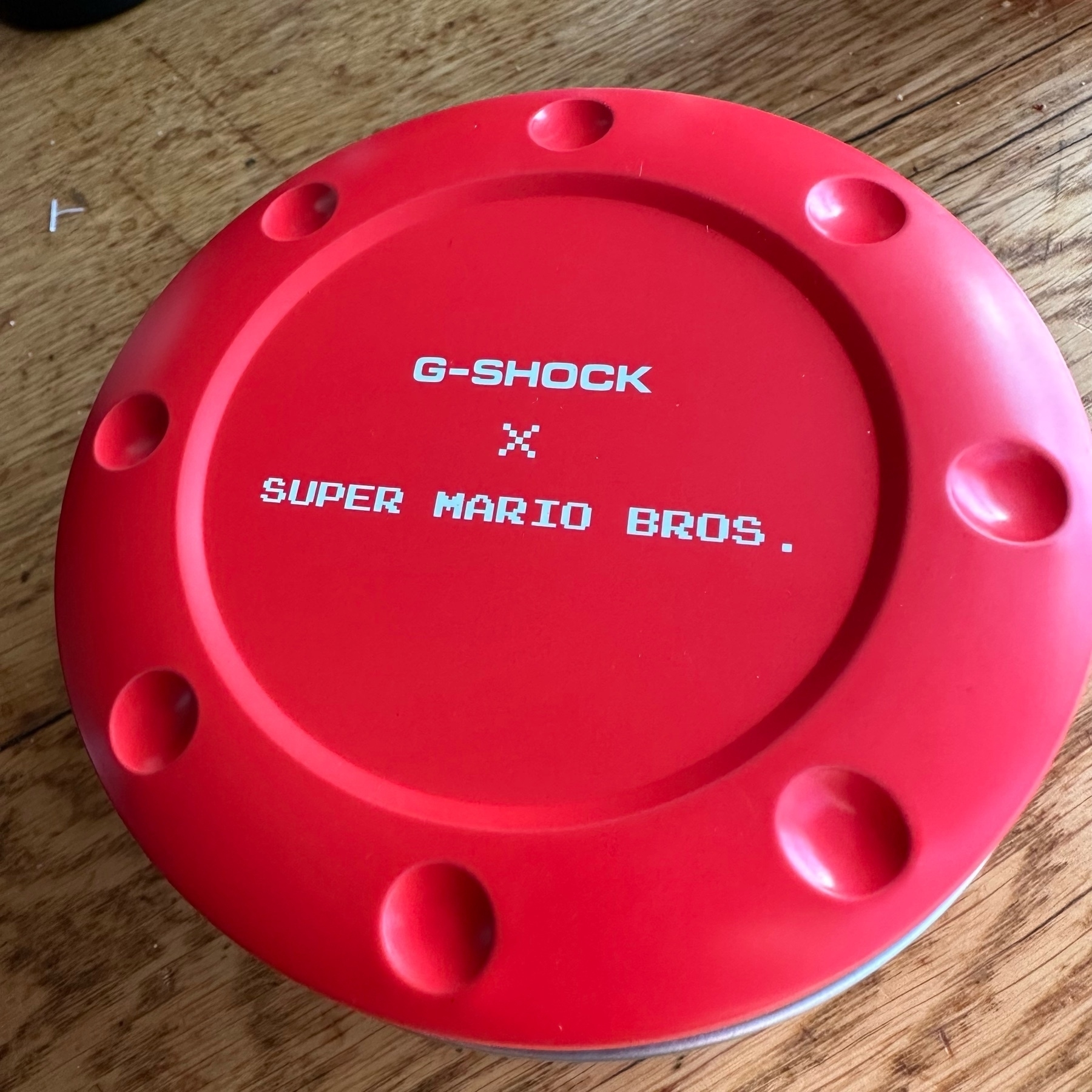 The very red top to the Casio G-Shock SUPER MARIO BROS watch tin